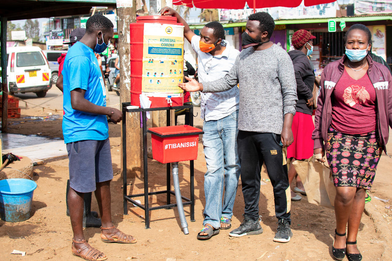 Wesley Onguso explaining on best ways to use a hand washing station
